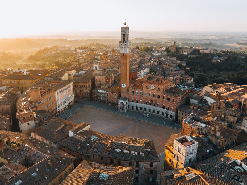 The shell-shaped Piazza del Campo in Siena at golden hour